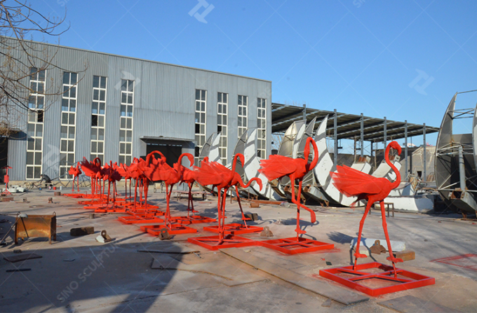 The red color paint is applied to red Flamingo sculptures.